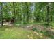 View of the peaceful yard showcasing lush landscaping and mature trees at 804 Old Mill Rd, Chapel Hill, NC 27514