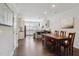 Bright dining area with hardwood floors, a wooden table, and a view into a modern, updated kitchen at 805 Winter Meadow Dr, Wake Forest, NC 27587