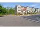 Exterior view of modern townhomes showcasing varying color schemes and stylish design elements at 805 Winter Meadow Dr, Wake Forest, NC 27587