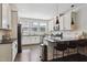 Modern kitchen featuring white cabinets, granite countertops, stainless steel appliances, and hardwood floors at 805 Winter Meadow Dr, Wake Forest, NC 27587