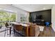 Modern living room boasts a cozy couch, sleek dark accent wall with TV, and patio view for a relaxing space at 805 Winter Meadow Dr, Wake Forest, NC 27587