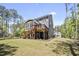 Exterior view of the backyard features a screened porch, a deck, and mature trees at 8237 Baronleigh Ln, Wake Forest, NC 27587