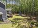 Aerial view of the home's backyard, highlighting the treed lot and playground at 8237 Baronleigh Ln, Wake Forest, NC 27587