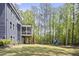 Beautiful backyard featuring a screened porch and a playset surrounded by lush greenery at 8237 Baronleigh Ln, Wake Forest, NC 27587
