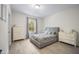 Cozy bedroom with neutral tones, a comfortable bed, and natural light streaming through the window at 8237 Baronleigh Ln, Wake Forest, NC 27587