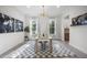 Bright dining room with modern light fixture, a neutral rug, and a view of the outdoors at 8237 Baronleigh Ln, Wake Forest, NC 27587