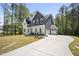 Attractive two-story home with a long driveway, attached garage, manicured lawn and mature trees at 8237 Baronleigh Ln, Wake Forest, NC 27587