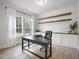 Bright home office with a large arched window, built-in cabinets, and rustic wooden shelving at 8237 Baronleigh Ln, Wake Forest, NC 27587