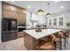 Open concept kitchen with stone countertops, stainless steel appliances, ample cabinetry, and center island at 8237 Baronleigh Ln, Wake Forest, NC 27587