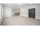 Open living area with hardwood floors, neutral walls, and a staircase leading to the upper level at 8237 Baronleigh Ln, Wake Forest, NC 27587