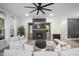 Cozy living room featuring a fireplace, modern furniture, hardwood floors, and a decorative ceiling fan at 8237 Baronleigh Ln, Wake Forest, NC 27587