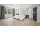 Spacious main bedroom with large windows, neutral decor, and dark wood nightstands at 8237 Baronleigh Ln, Wake Forest, NC 27587