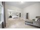 Large main bedroom with seating area and view into sleeping space with natural light and light wood floors at 8237 Baronleigh Ln, Wake Forest, NC 27587