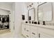 Stylish bathroom with double vanities, modern fixtures, and a walk-in closet at 8426 Garnet Rose Ln, Raleigh, NC 27615
