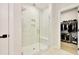 Modern bathroom featuring a glass-enclosed shower and walk-in closet at 8426 Garnet Rose Ln, Raleigh, NC 27615