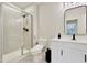 Modern bathroom featuring a tiled shower, glass enclosure, and sleek fixtures at 8426 Garnet Rose Ln, Raleigh, NC 27615