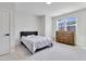 Clean bedroom with modern bed, soft carpet, and bright window with a view at 8426 Garnet Rose Ln, Raleigh, NC 27615