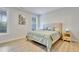 Cozy bedroom with hardwood floors, large windows, and neutral decor at 8426 Garnet Rose Ln, Raleigh, NC 27615