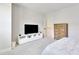 Bright bedroom with a dresser, TV, and soft carpet, offering a comfortable space at 8426 Garnet Rose Ln, Raleigh, NC 27615