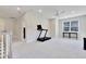 Expansive bonus room featuring a treadmill, a window, and recessed lighting at 8426 Garnet Rose Ln, Raleigh, NC 27615