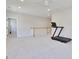 Large bonus room with a ceiling fan, neutral carpet, and a visible staircase at 8426 Garnet Rose Ln, Raleigh, NC 27615