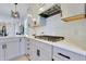 Close-up of kitchen featuring granite countertops, stainless steel appliances, and grey cabinets at 8426 Garnet Rose Ln, Raleigh, NC 27615