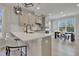 Modern kitchen with quartz countertops, stainless steel appliances, and breakfast bar seating at 8426 Garnet Rose Ln, Raleigh, NC 27615