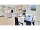 Open concept kitchen features stainless steel appliances, island and adjacent dining area at 8426 Garnet Rose Ln, Raleigh, NC 27615