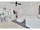 Bright, open-concept living space featuring a white sofa, modern decor, and hardwood floors at 8426 Garnet Rose Ln, Raleigh, NC 27615