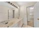 Bathroom featuring a double sink vanity and large mirror at 8629 Swarthmore Dr, Raleigh, NC 27615