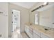 Well-lit bathroom with double sinks, vanity and tiled floor, plus an adjoining room with toilet at 8629 Swarthmore Dr, Raleigh, NC 27615