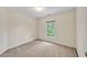 Neutral carpeted bedroom with natural light streaming in from a window at 8629 Swarthmore Dr, Raleigh, NC 27615