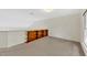Spacious carpeted bonus room with a custom built-in wooden shelving unit at 8629 Swarthmore Dr, Raleigh, NC 27615