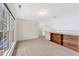 Carpeted bonus room with a large window and custom built-in wooden shelving at 8629 Swarthmore Dr, Raleigh, NC 27615
