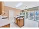 Bright kitchen with open layout, white appliances, wooden cabinets, and a view to the dining area at 8629 Swarthmore Dr, Raleigh, NC 27615