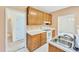 Functional kitchen with wooden cabinetry, white countertops, and a stainless steel sink basin at 8629 Swarthmore Dr, Raleigh, NC 27615
