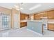 A cozy kitchen features ample cabinet space, a breakfast bar, and a door to the backyard at 8629 Swarthmore Dr, Raleigh, NC 27615