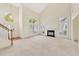 Bright living room with soaring ceilings, large windows, and a cozy fireplace for comfortable living at 8629 Swarthmore Dr, Raleigh, NC 27615