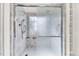 Modern shower with sleek glass enclosure and chrome fixtures against light marble patterned walls at 8629 Swarthmore Dr, Raleigh, NC 27615
