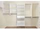 Organized walk-in closet with adjustable shelving and drawer unit for ample storage at 8629 Swarthmore Dr, Raleigh, NC 27615