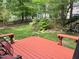 View from the backyard deck showcasing the lush greenery, waterfall, and landscaped yard at 8712 Attingham Dr, Raleigh, NC 27615