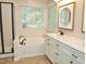 Bathroom with a tub, a black framed shower, and a white vanity with double sinks at 8712 Attingham Dr, Raleigh, NC 27615