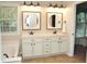 Spacious bathroom features dual sinks, a large mirror, and a view of the backyard at 8712 Attingham Dr, Raleigh, NC 27615