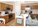 Well-equipped kitchen with stainless steel appliances, wooden cabinets, and an open counter overlooking the adjacent dining area at 8712 Attingham Dr, Raleigh, NC 27615