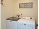 Laundry room with modern Maytag washer and dryer units and a sign on the wall at 8712 Attingham Dr, Raleigh, NC 27615