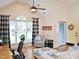 Bright and airy living room with a vaulted ceiling, hardwood floors, a large window, and a comfortable seating area with a computer at 8712 Attingham Dr, Raleigh, NC 27615