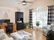 Bright and airy living room with a vaulted ceiling, hardwood floors, a large window, and a comfortable seating area with a computer at 8712 Attingham Dr, Raleigh, NC 27615
