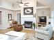 Inviting living room featuring a fireplace, vaulted ceiling, ceiling fan, and comfortable seating with a horse motif weathervane at 8712 Attingham Dr, Raleigh, NC 27615