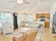 Spacious living room with a vaulted ceiling, ceiling fan, hardwood floors, and an open layout connecting to the kitchen and dining area at 8712 Attingham Dr, Raleigh, NC 27615