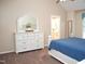 The main bedroom shows a dresser with white mirror and the doorway to the bathroom at 8712 Attingham Dr, Raleigh, NC 27615